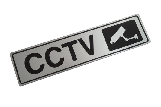 CCTV In Operation Adhesive Sign – Brushed Silver Aluminium 50×195mm – by North By North East – Security & CCTV Signs